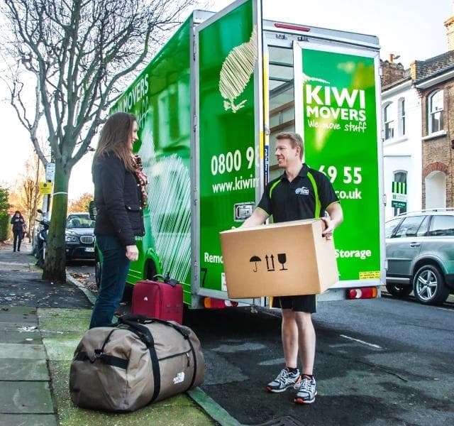 people standing in front of kiwi truck