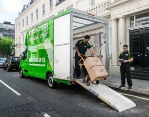 men carrying the boxes out of the kiwi van